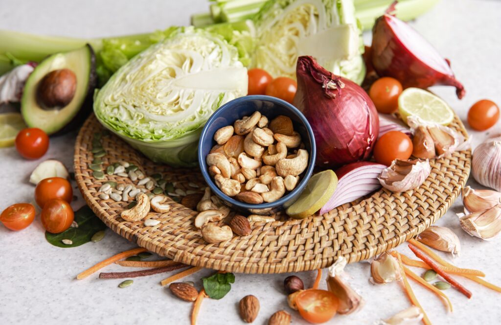 Close-up, a bowl of cashew nuts and other healthy foods on the kitchen table.